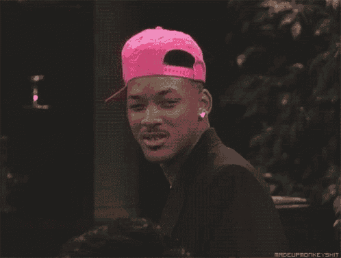 a man wearing a pink hat with the words raceupmonkeyshit below it