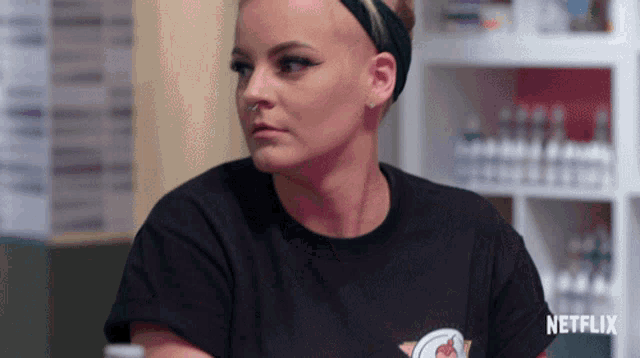 a woman wearing a black shirt that says netflix on the front