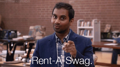 a man in a suit pointing at the camera with the words rent a swag written below him