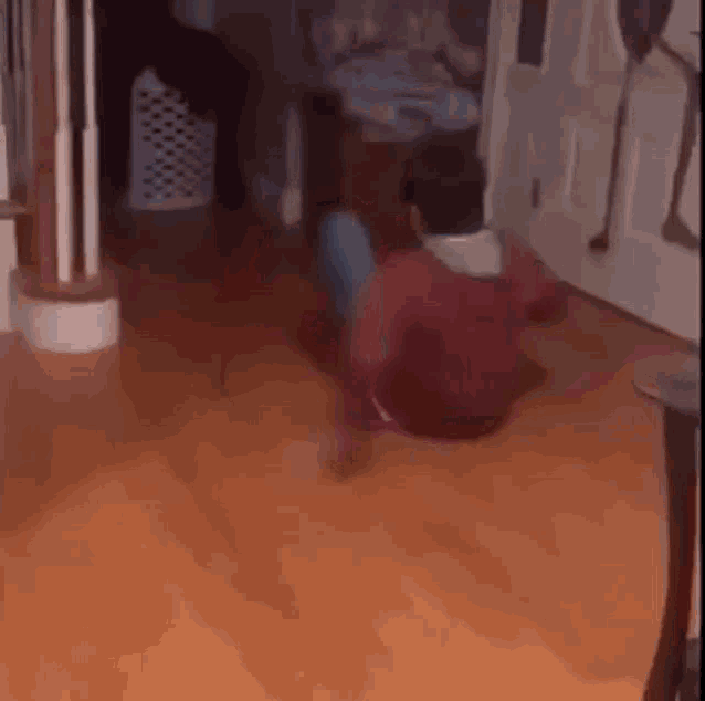 a man is sitting on the floor in a living room and dancing .