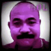 a close up of a man 's face with a mustache and a bald head .