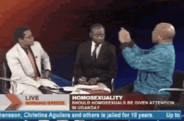 a news report about homosexuality in uganda is shown on a television screen