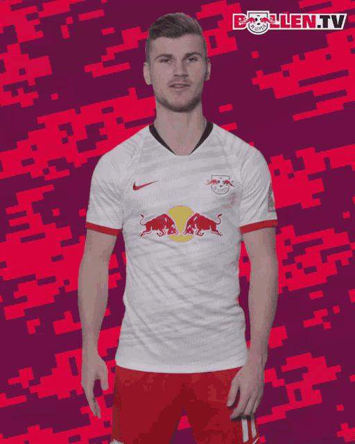 a man is wearing a white shirt with red bulls on it