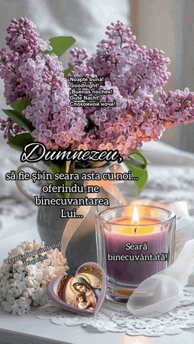 purple flowers in a vase next to a candle and a heart