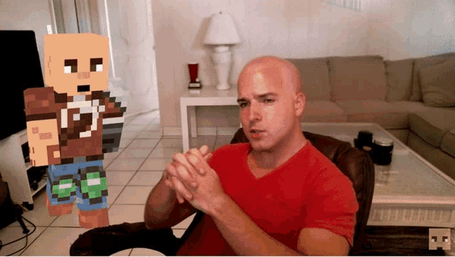 a man in a red shirt is sitting in a chair with his hands folded in front of a minecraft character