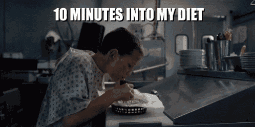 a person in a hospital gown is eating a hamburger with the caption 10 minutes into my diet .