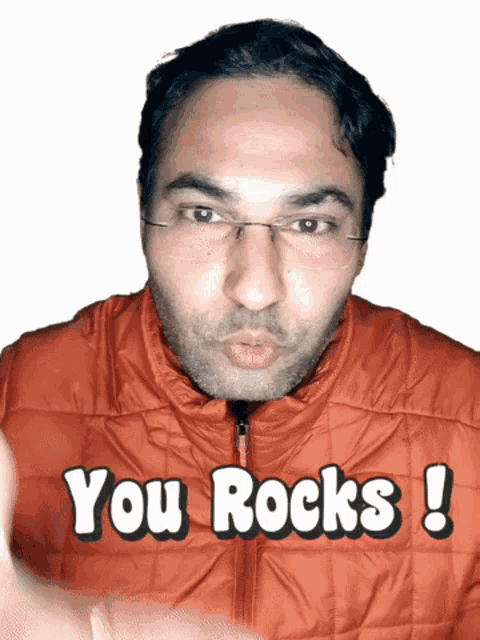 a man wearing glasses and an orange jacket says you rocks !