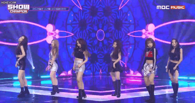 a group of girls are performing on a stage and the words show champion are on the screen