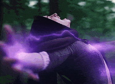 a person with their arms outstretched and a purple light coming out of their hands