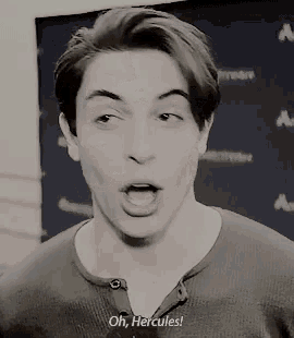 a young man is making a funny face and saying `` oh , hercules '' .