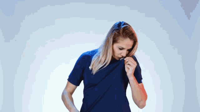 a woman wearing a blue nike shirt with a french flag on her chest