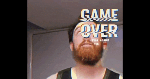 a man with a beard is standing in front of a game over sign