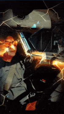 a man wearing sunglasses is sitting in a car with a reflection of him in the windshield