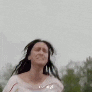 a blurry picture of a woman standing in front of a forest with the words `` no mi gf '' written on the bottom .