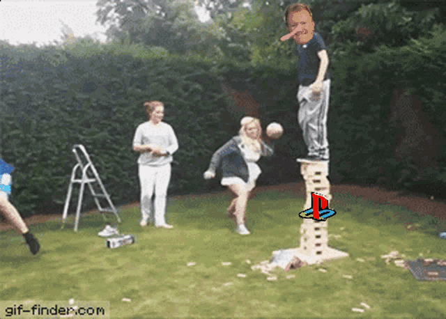 a group of people are playing jenga with a playstation logo on the tower