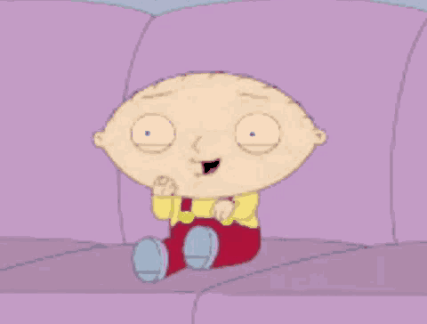 stewie from family guy is sitting on a purple couch and smiling .