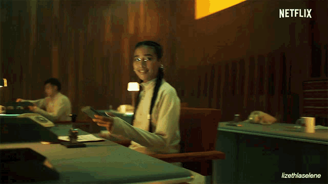 a woman is reading a book next to a cup that says like