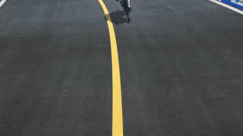 a person riding a bike on a road with a yellow line on it