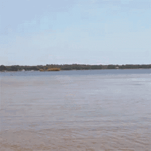 a man in shorts is running into the water