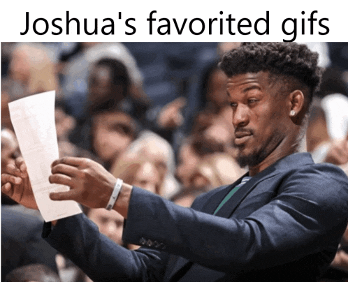 a man in a suit holds up a piece of paper with the caption " joshua 's favorite gifs " above him