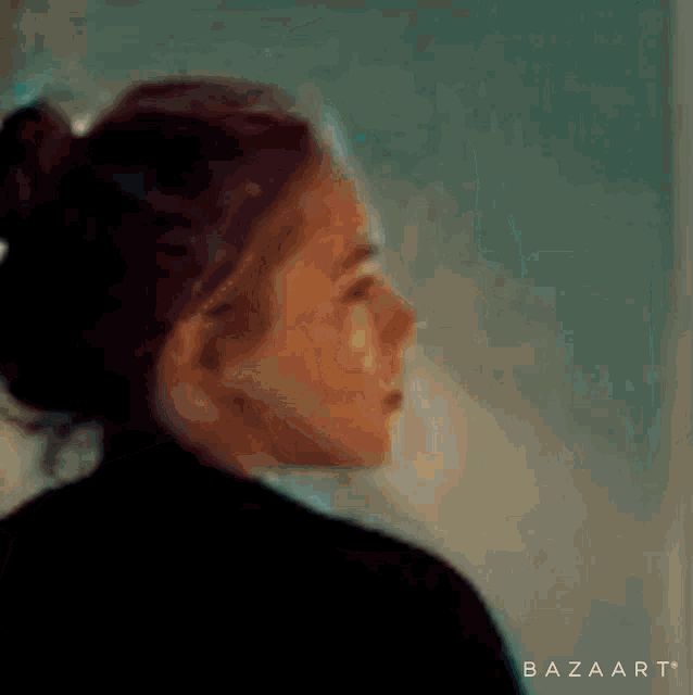 a close up of a woman 's face in a blurry photo .