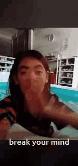 a girl in a pool with the words break your mind on the bottom right