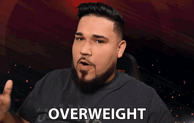 a man with a beard wearing a black shirt that says overweight