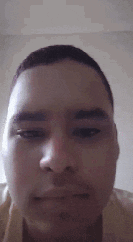 a close up of a man 's face with his eyes closed and a beard .