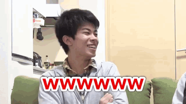 a man sitting on a couch with the words wwwwww on the bottom of his face