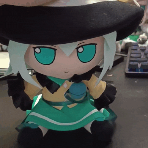 a stuffed doll with green eyes and white hair