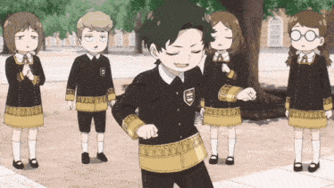 a group of children are standing around a boy wearing a black and gold uniform with the letter h on the front