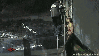 a man in a black shirt with the number 23 on it is jumping over a ladder