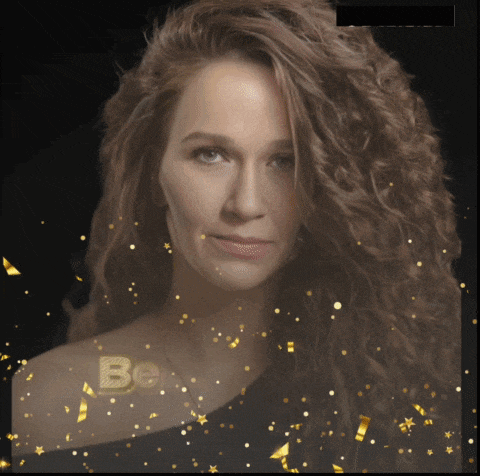 a woman 's face is surrounded by gold confetti and the word be