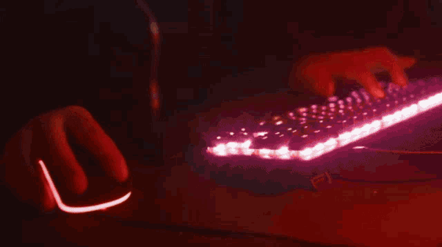a man wearing headphones and a microphone is sitting in front of a computer screen .