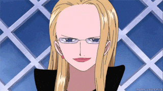 a woman with blonde hair and glasses is smiling in front of a white fence