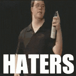a man holding a spray bottle with the word haters written on it