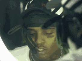 a close up of a man 's face with a bandana on his head .