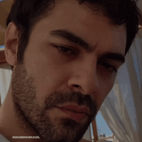 a close up of a man 's face with the words gokberkbrazil on the bottom