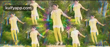 a group of women in yellow dresses are dancing in front of trees with the website kulfyapp.com at the bottom