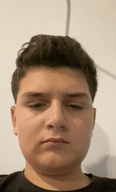 a close up of a young man 's face with a white background