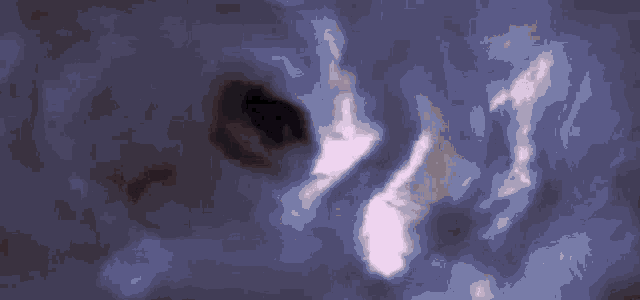 a close up of a black hole in the middle of a galaxy in space .