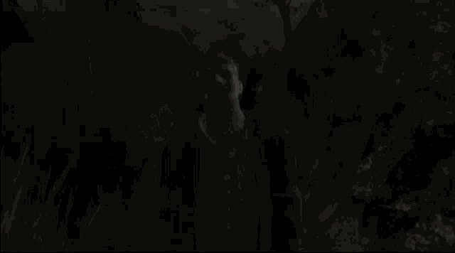 a monster with a long neck is standing in the dark with trees in the background