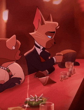 a cat in a tuxedo sits at a table