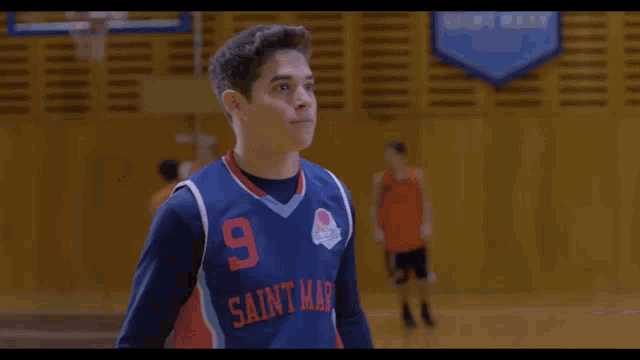 a basketball player wearing a saint mary jersey clapping his hands