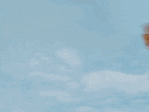 tails from sonic the hedgehog is flying through the air in a blurred image .