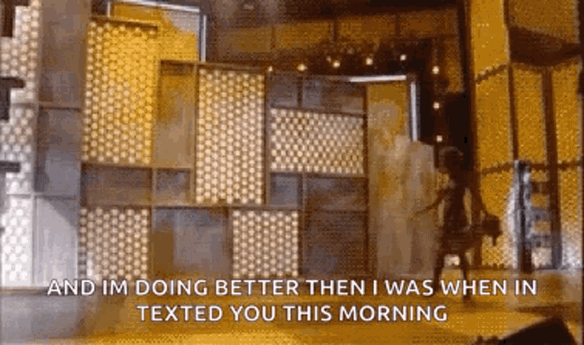 a man is standing in front of a wall with the words and im doing better then i was when i texted you this morning