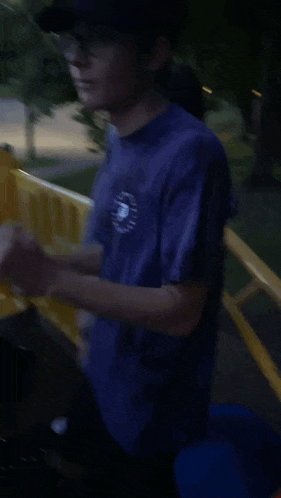 a man in a blue shirt with the letter p on it