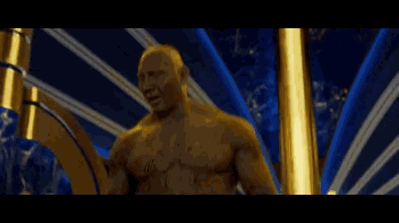a statue of a man with gold paint on his face is laughing