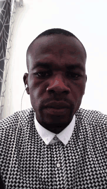 a man wearing a black and white checkered shirt