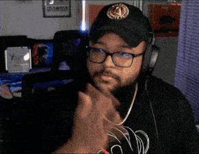 a man wearing headphones and a hat with the letter a on it is clapping
